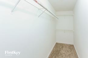 Atlanta house for rent - A white bedroom with a carpeted floor and a white bed frame.