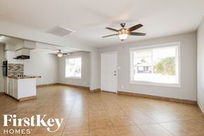 Phoenix house for rent - an empty kitchen and living room with a ceiling fan
