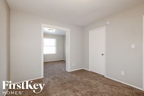 Phoenix house for rent - a bedroom with white walls and carpet and a door to a closet