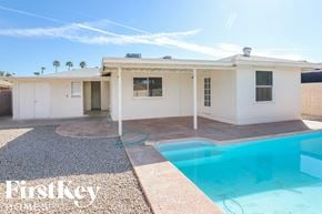 Phoenix house for rent - a home with a swimming pool and a white house