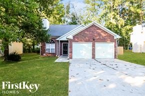 Atlanta house for rent - a house with a driveway and a garage door