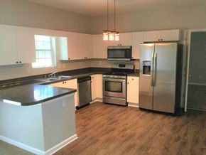 Atlanta house for rent - a kitchen with stainless steel appliances and a wooden floor