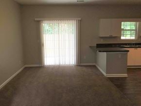 Atlanta house for rent - an empty living room with a door to a kitchen
