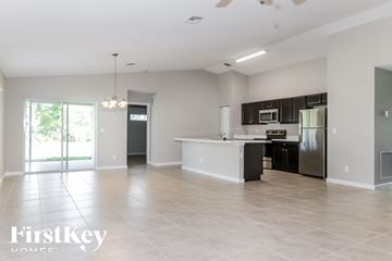 Port St. Lucie house for rent - A spacious kitchen with a refrigerator, microwave, and oven.