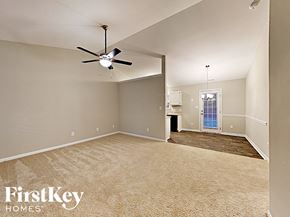Charlotte house for rent - an empty living room with a ceiling fan