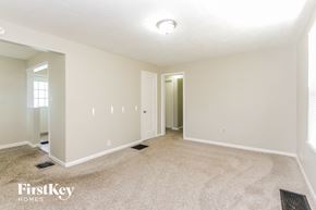 Indianapolis house for rent - A carpeted room with a doorway leading to another room.