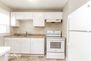 Indianapolis house for rent - A kitchen with white cabinets and appliances.
