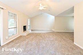 Spring house for rent - A spacious room with a carpeted floor and a ceiling fan.