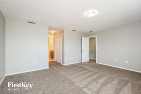 Kissimmee house for rent - a spacious living room with carpeting and white walls