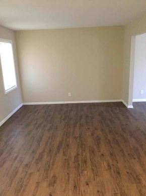 Decatur house for rent - an empty living room with a wooden floor