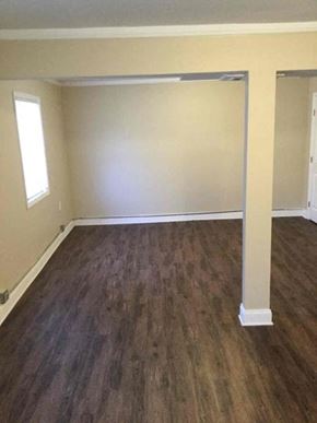 Decatur house for rent - an empty living room with a wooden floor