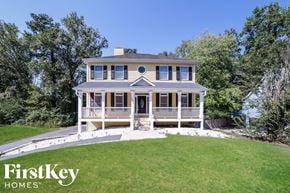Marietta house for rent - a house with a lawn and a ramp to the front door