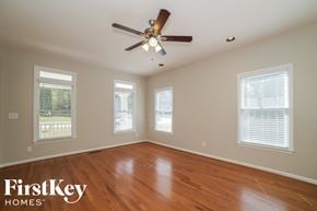 Marietta house for rent - a living room with wood floors and a ceiling fan