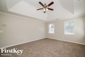 Marietta house for rent - a bedroom with a ceiling fan and a carpeted floor
