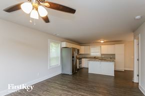 Cumming house for rent - A spacious kitchen with a ceiling fan and wooden flooring.