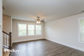 Cumming house for rent - A room with a wooden floor and a ceiling fan.