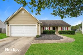 Greensboro house for rent - a home with a white garage door and a driveway
