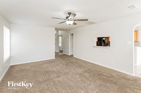 Spring house for rent - A spacious room with a carpeted floor and a ceiling fan.