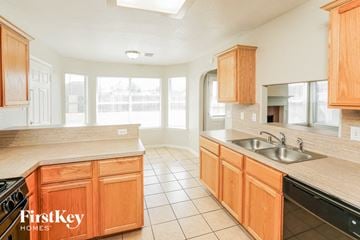 Spring house for rent - A kitchen with wooden cabinets and a stove top oven.