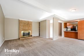 Florissant house for rent - A spacious living room with a fireplace and built-in shelves.
