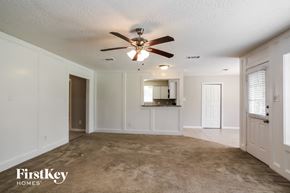 Spring house for rent - A spacious room with a carpeted floor and a ceiling fan.