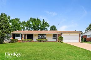 Florissant house for rent - a home with a green lawn and a white house