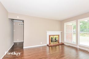 Florissant house for rent - a living room with wood floors and a fireplace