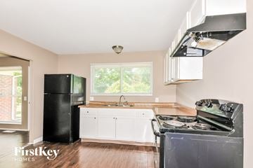 Florissant house for rent - a kitchen with a stove and a refrigerator and a sink