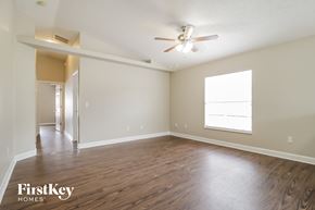 Sanford house for rent - an empty living room with wood flooring and a ceiling fan