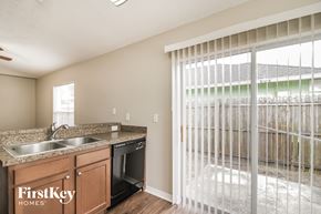 Sanford house for rent - a kitchen with a sink and a window with a sliding glass door