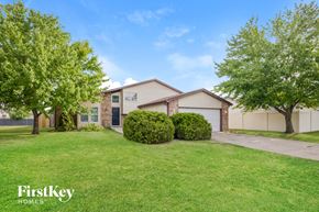 Crest Hill house for rent - a home with a lawn and trees in front of it