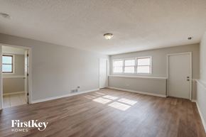 Crest Hill house for rent - the spacious living room with wood flooring and white walls