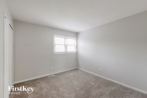 Crest Hill house for rent - a bedroom with white walls and carpet and a window