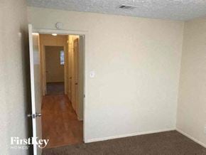 Sugar Land house for rent - an empty living room with a door to a hallway