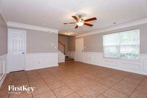 Charlotte house for rent - A spacious room with a ceiling fan and tiled floor.