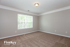 Charlotte house for rent - A room with a carpeted floor and a window with blinds.
