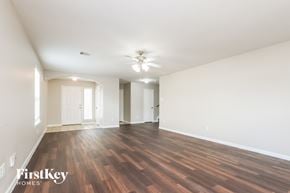 Houston house for rent - A spacious room with wooden floors and white walls.
