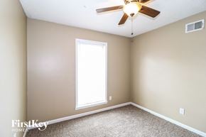 Memphis house for rent - a bedroom with a ceiling fan and a window
