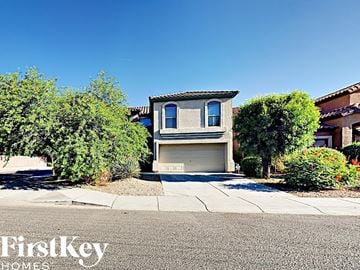 Phoenix house for rent - a house with a garage door on a street