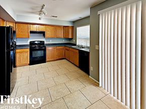 Phoenix house for rent - a kitchen with black appliances and wooden cabinets