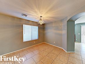 Phoenix house for rent - an empty dining room with tile flooring and a chandelier