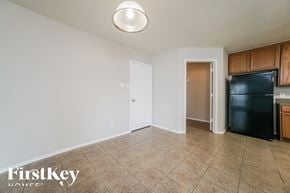 Hockley house for rent - a kitchen with a black refrigerator and tile flooring