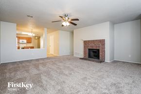 Lancaster house for rent - an empty living room with a fireplace and a ceiling fan