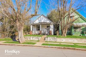 Kansas City house for rent - a green house with a sidewalk in front of it