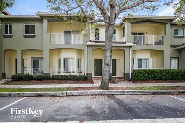 Homestead house for rent - an apartment building with a sidewalk and trees in front of it