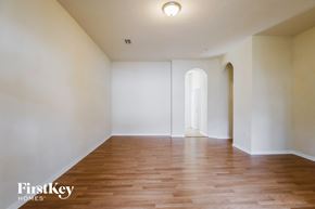 Homestead house for rent - an empty living room with white walls and wood floors