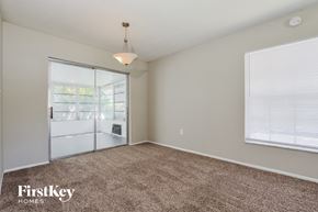 Mount Dora house for rent - an empty living room with a window and a door to a kitchen