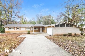 Decatur house for rent - a white house with a driveway and a white door