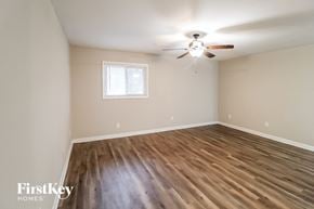 Decatur house for rent - the spacious living room with hardwood flooring and a ceiling fan