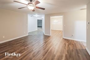 Decatur house for rent - the living room and dining room with hardwood flooring and a ceiling fan